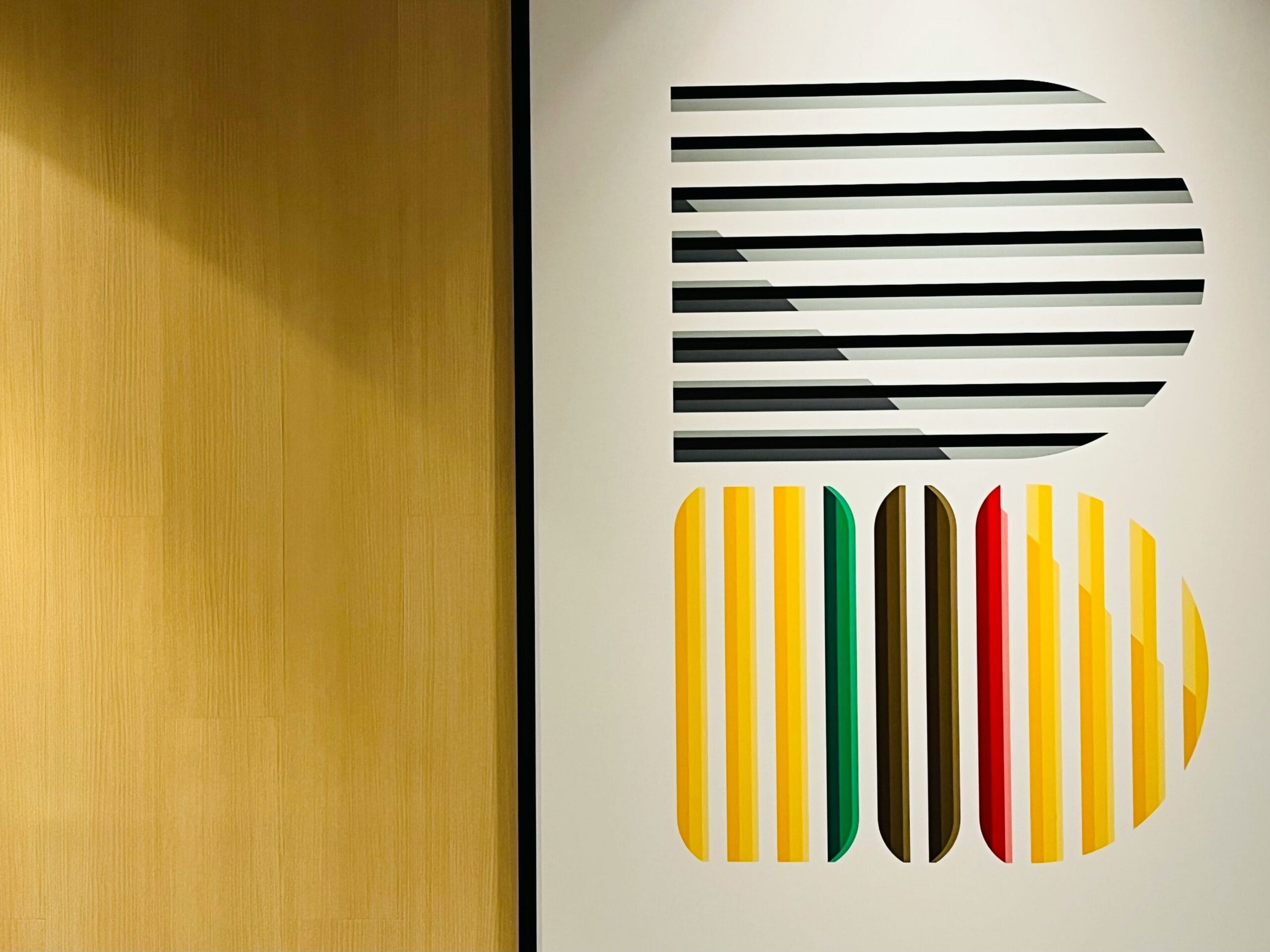 Geometric optical art with bold color stripes representing the design philosophies of Alessi and Areaware