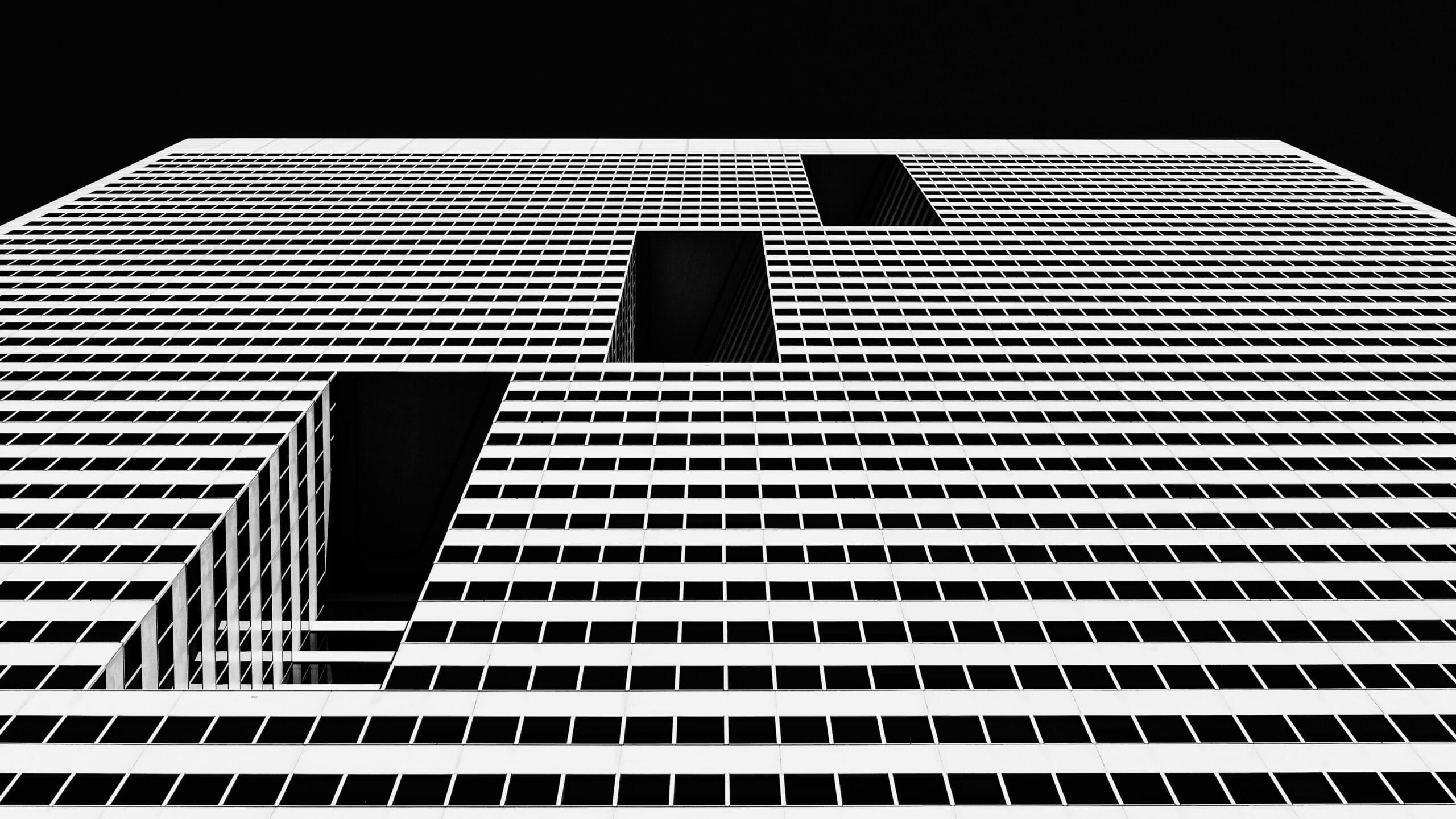 Black and white geometric building grid representing Dieter Rams minimalist design principles