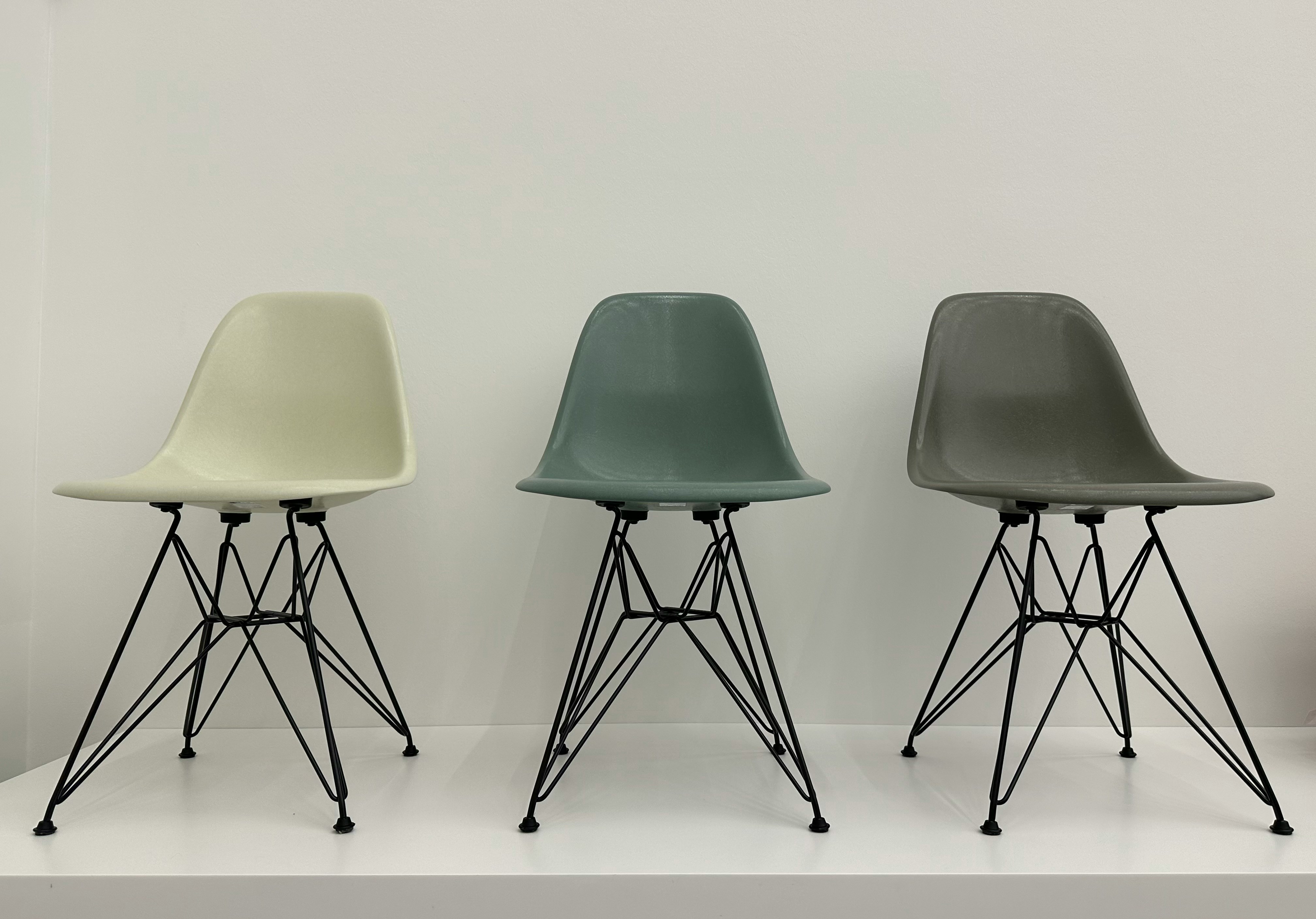 Eames DSR shell chairs in sage green and grey on Eiffel Tower wire bases
