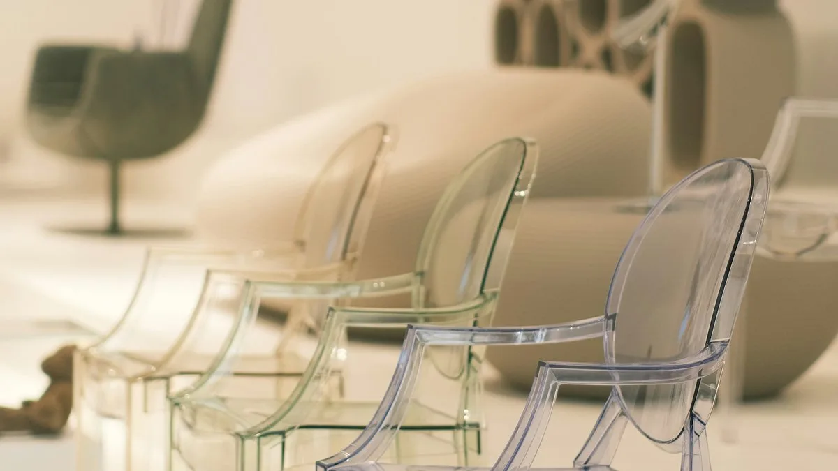 Row of transparent polycarbonate Ghost chairs by Kartell in a modern interior