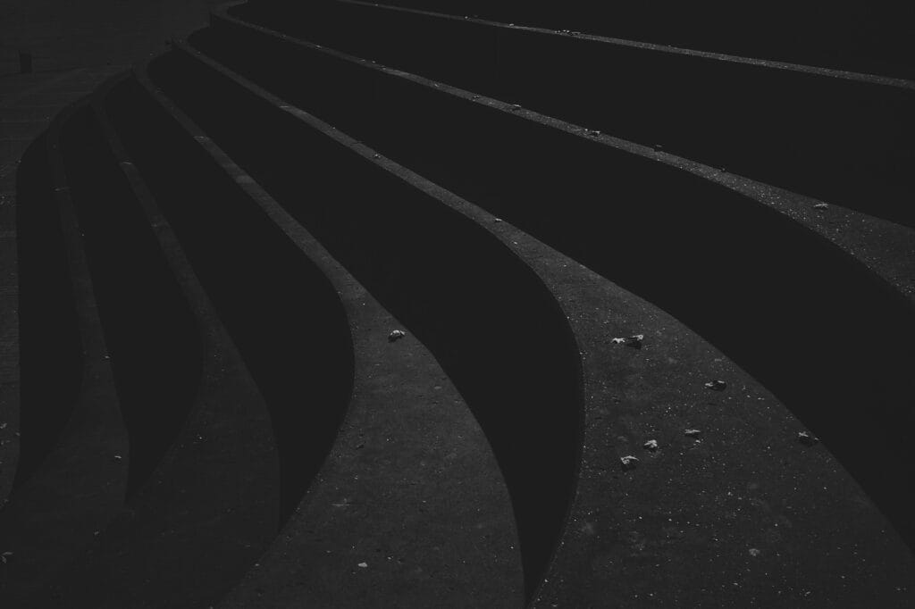 Dark curved architectural steps evoking the sculptural forms of iconic furniture design