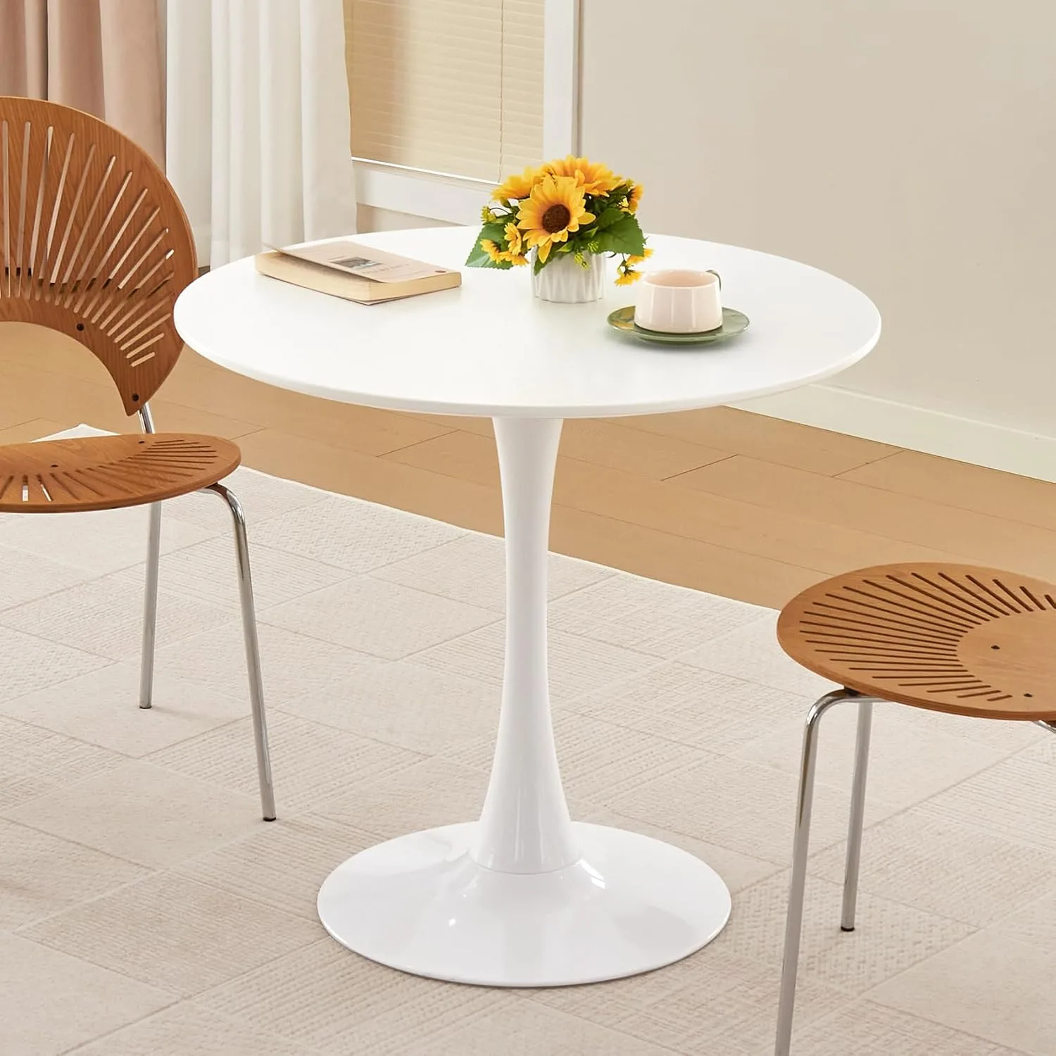Detail of Saarinen Tulip Chair pedestal base showing the Rilsan-coated cast aluminum column meeting the fiberglass shell — the design's key material illusion
