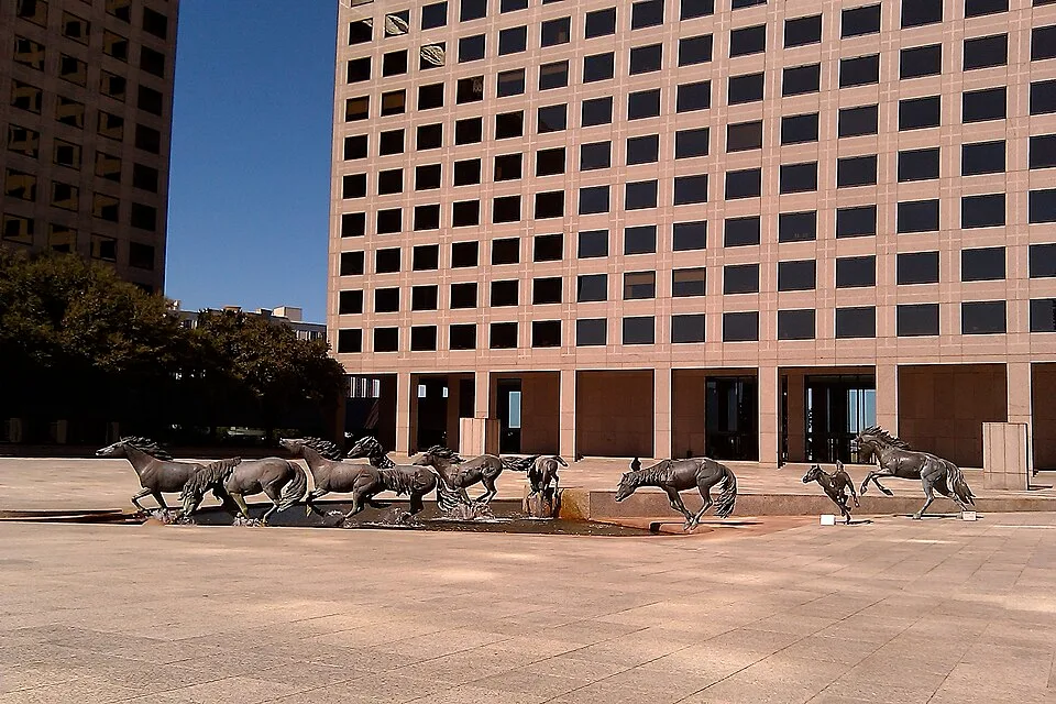 Mustangs of Las Colinas by Robert Glen, nine bronze mustangs in full gallop, Williams Square, Irving Texas, 1984