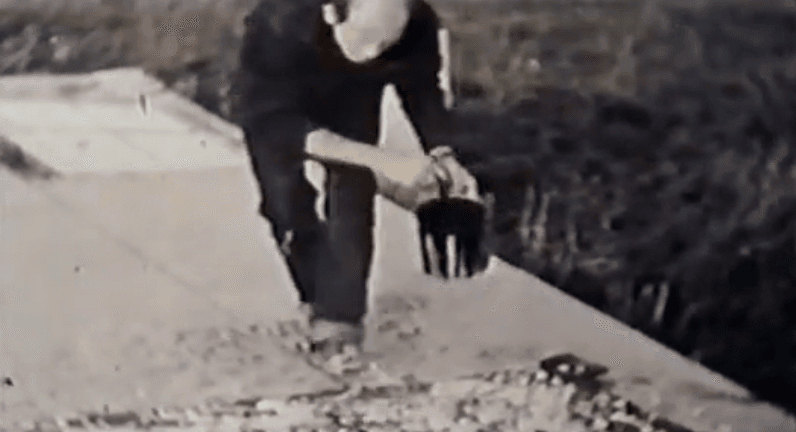 Jackson Pollock working on a canvas painting in his studio
