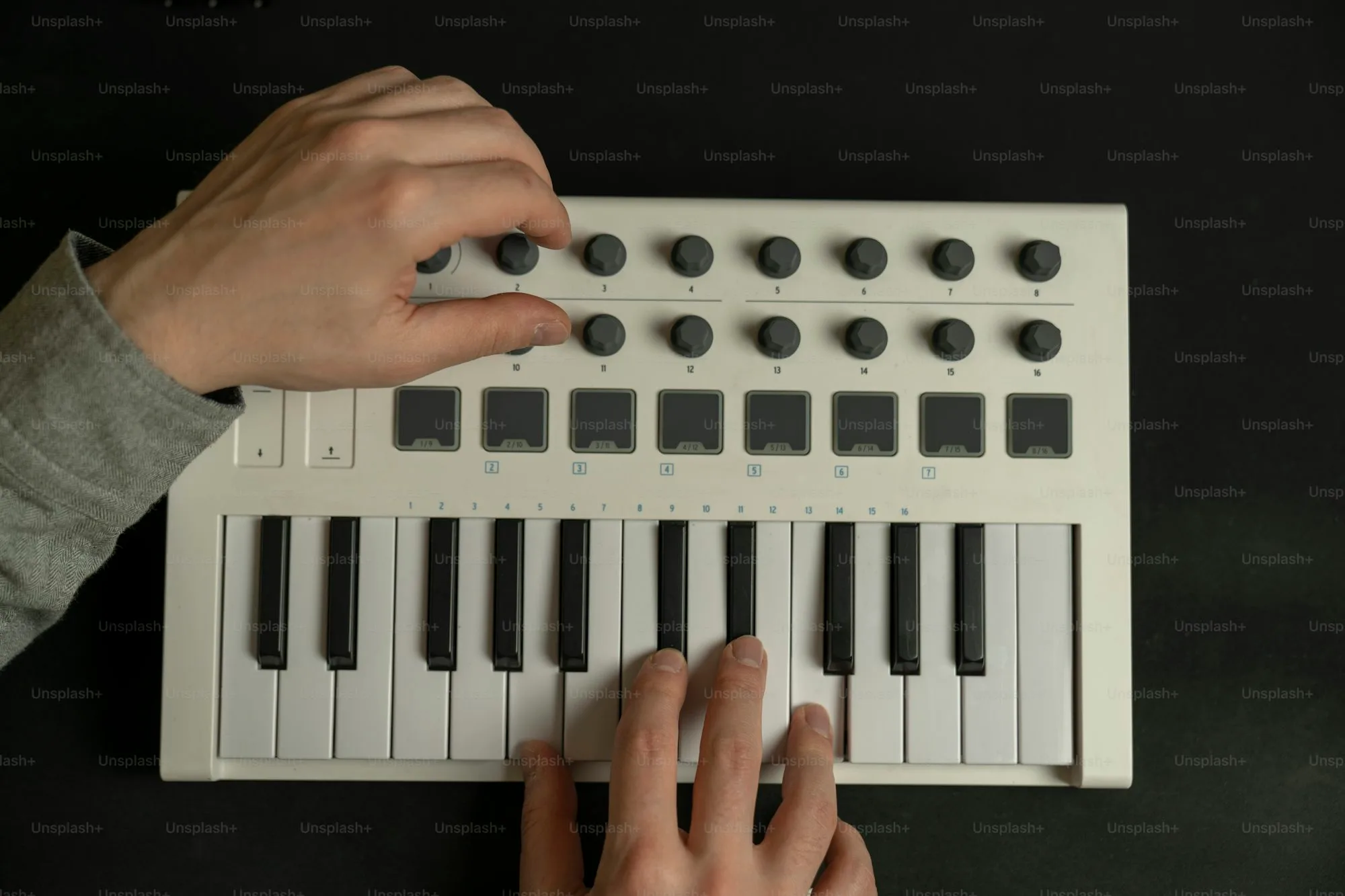 Close-up of synthesizer control knobs and buttons showing tactile interface design