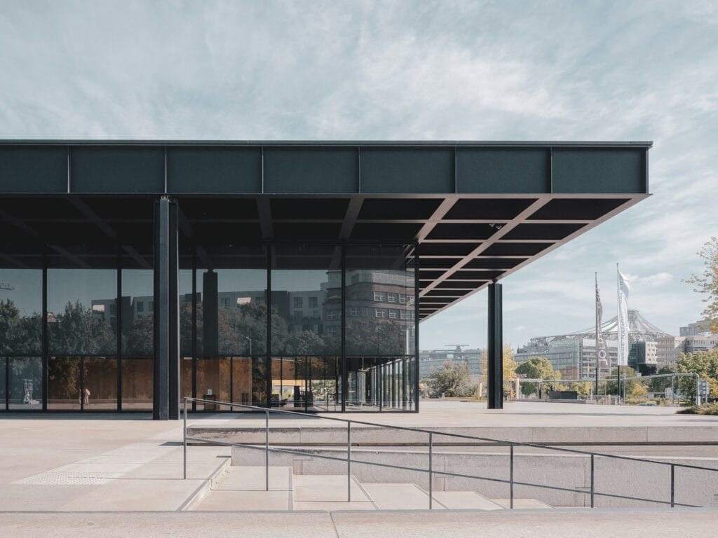 Large modernist building with glass curtain walls and steel structure